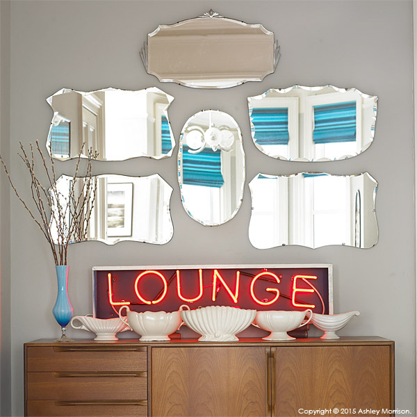  Display of mirrors and Lounge sign in the sitting room of Keri Johnston'stownhouse.