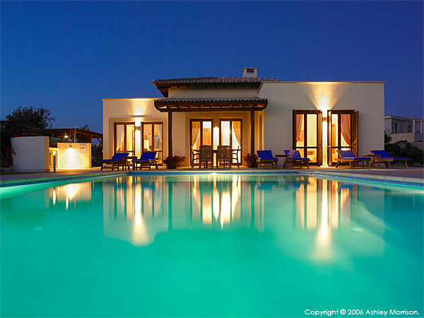 The swimming pool at night outside Villa Thalia at Aphrodite Hills near Paphos in Cyprus.